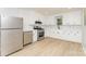 Recently renovated kitchen with stainless steel appliances, white cabinets, and new flooring at 3724 Patricia Nw Dr, Concord, NC 28027