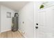 Utility room with water heater, laundry hookups, and access door to outside at 3724 Patricia Nw Dr, Concord, NC 28027
