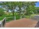 This deck offers scenic backyard views of lawn and mature trees at 3729 Woodleaf Rd, Charlotte, NC 28205