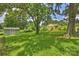 Backyard with green lawn, mature trees and shed on a sunny day at 3729 Woodleaf Rd, Charlotte, NC 28205