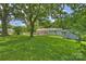 The backyard features a lush green lawn, storage shed, and a deck that extends from the house at 3729 Woodleaf Rd, Charlotte, NC 28205