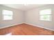 Bright bedroom features hardwood floors and natural light from two windows at 3729 Woodleaf Rd, Charlotte, NC 28205