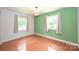 Bedroom with hardwood floors and two large windows bringing in natural light at 3729 Woodleaf Rd, Charlotte, NC 28205
