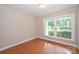 Bright bedroom with hardwood floors and natural light from large windows at 3729 Woodleaf Rd, Charlotte, NC 28205