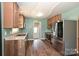 Modern kitchen featuring stainless steel appliances and custom cabinets, leading to backyard access at 3729 Woodleaf Rd, Charlotte, NC 28205