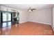 Open-concept living area with hardwood floors flowing into the dining area with modern stainless steel appliances at 3729 Woodleaf Rd, Charlotte, NC 28205