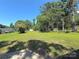 Expansive backyard featuring a well-maintained lawn, mature trees, a storage shed and play equipment at 419 Lige St, Rock Hill, SC 29730