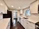 Well-lit kitchen boasts white cabinetry, stainless steel appliances, and connecting rooms at 419 Lige St, Rock Hill, SC 29730