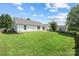 Large, grassy backyard featuring a partial fence, ideal for Gathering gatherings or pets, and access to back of home at 4697 Madeline Dr, Rock Hill, SC 29732