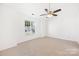Bright bedroom with neutral carpet, ceiling fan, and large window at 4697 Madeline Dr, Rock Hill, SC 29732