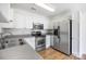 Spacious kitchen featuring stainless steel appliances, white cabinets, and modern countertops at 4697 Madeline Dr, Rock Hill, SC 29732