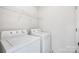 Functional laundry room with white washer and dryer, and wire shelving at 4697 Madeline Dr, Rock Hill, SC 29732