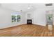 Spacious living room featuring hardwood floors, natural light, a fireplace, and a ceiling fan at 4697 Madeline Dr, Rock Hill, SC 29732