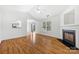 Open-concept living room with hardwood floors, a fireplace, and sliding glass doors to the patio at 4697 Madeline Dr, Rock Hill, SC 29732