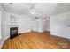 Bright and open floor plan with hardwood floors, a fireplace, and a ceiling fan at 4697 Madeline Dr, Rock Hill, SC 29732
