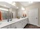 Bathroom with dual sinks, an oversized mirror, and tiled shower with glass door at 515 Stickley Pl, Lancaster, SC 29720