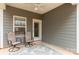 Cozy patio with seating, an outdoor rug, and a view through the window and glass door at 515 Stickley Pl, Lancaster, SC 29720