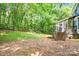 View of a backyard with fence, and a staircase leading to a screened-in porch at 5238 Downing Creek Dr, Charlotte, NC 28269