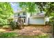 A backyard with a screened-in porch and wooden steps leading to the grassy area at 5238 Downing Creek Dr, Charlotte, NC 28269