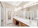 Bathroom featuring double sinks with wood cabinets, large mirror, and separate shower and toilet rooms at 5238 Downing Creek Dr, Charlotte, NC 28269
