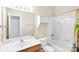 Bathroom featuring sink vanity, toilet, tub, and shower with white tile and a light-colored curtain at 5238 Downing Creek Dr, Charlotte, NC 28269
