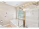 Bright bathroom featuring a jacuzzi tub and a separate shower with a gold-trimmed glass door at 5238 Downing Creek Dr, Charlotte, NC 28269