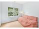 Bedroom with neutral carpet and pale blue walls, window, and pink daybed at 5238 Downing Creek Dr, Charlotte, NC 28269