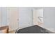 Neutral bedroom with a white door and trim, and a view to the stairway at 5238 Downing Creek Dr, Charlotte, NC 28269