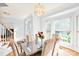 Elegant dining room featuring a chandelier, bay window, and seating for six at 5238 Downing Creek Dr, Charlotte, NC 28269
