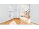 View of the dining area showcasing hardwood floors, staircase, and chandelier at 5238 Downing Creek Dr, Charlotte, NC 28269