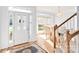Inviting foyer with hardwood floors, staircase, chandelier, and a view of the dining area at 5238 Downing Creek Dr, Charlotte, NC 28269
