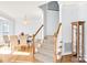 Inviting foyer featuring hardwood floors, staircase, and dining area with elegant chandelier at 5238 Downing Creek Dr, Charlotte, NC 28269