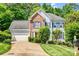 Charming two-story home featuring a well-manicured lawn, brick accents, and a two-car garage at 5238 Downing Creek Dr, Charlotte, NC 28269
