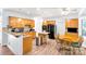 Charming kitchen features wood cabinets, island, dining area, and stainless steel appliances at 5238 Downing Creek Dr, Charlotte, NC 28269