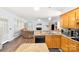 Open concept kitchen featuring a breakfast bar, wood cabinets, and view of the living area at 5238 Downing Creek Dr, Charlotte, NC 28269