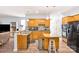 Spacious kitchen features wood cabinets, island, and open concept to living area at 5238 Downing Creek Dr, Charlotte, NC 28269
