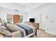 Bedroom features a wrought iron bed frame, tray ceiling, and natural light from windows at 5238 Downing Creek Dr, Charlotte, NC 28269