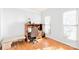 Bright home office with a desk, hardwood floors, and natural light from two windows at 5238 Downing Creek Dr, Charlotte, NC 28269