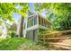 View of back of home with chimney and screened in porch, complemented by a backyard and a wooden fence at 5238 Downing Creek Dr, Charlotte, NC 28269
