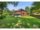 Expansive backyard featuring well-maintained lawn and a screened-in porch, ideal for outdoor entertaining at 5302 Fairgrove Ln, Harrisburg, NC 28075
