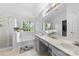 Bright bathroom featuring a double sink vanity, garden tub, and a separate glass enclosed shower at 5302 Fairgrove Ln, Harrisburg, NC 28075