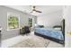 This bedroom has a ceiling fan, carpeted floors, and a desk near a window at 5302 Fairgrove Ln, Harrisburg, NC 28075