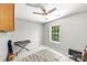 This bedroom has a ceiling fan, carpeted floors, and a large window with backyard view at 5302 Fairgrove Ln, Harrisburg, NC 28075