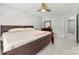 This bedroom has a ceiling fan, carpeted floors, and an attached bathroom at 5302 Fairgrove Ln, Harrisburg, NC 28075