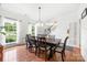 Bright dining room boasts hardwood floors, classic decor, and natural light from windows at 5302 Fairgrove Ln, Harrisburg, NC 28075