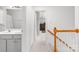 Second story hallway featuring wood railing and several doors, some leading to bathrooms at 5302 Fairgrove Ln, Harrisburg, NC 28075