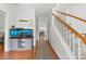 Bright hallway with hardwood floors, features an aquarium and staircase to the upper level at 5302 Fairgrove Ln, Harrisburg, NC 28075