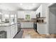 Modern kitchen with granite countertops, stainless steel appliances, and bright white cabinets at 5302 Fairgrove Ln, Harrisburg, NC 28075
