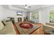 Relaxing living room featuring a fireplace, hardwood floors, and plenty of natural light at 5302 Fairgrove Ln, Harrisburg, NC 28075