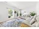 Airy living room boasts large windows, hardwood floors, and comfortable seating area at 5302 Fairgrove Ln, Harrisburg, NC 28075